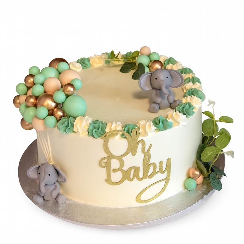 Ivory buttercream cake with a green and cream rosette border, two grey fondant elephants, a cluster of mint, peach and gold balloons and a gold glitter Oh Baby cutout on the side.