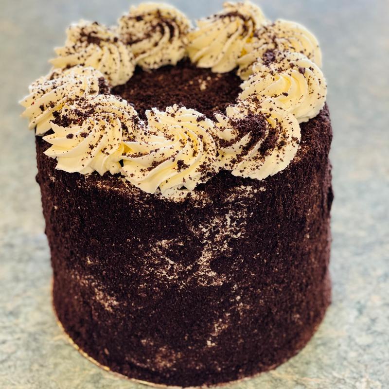 Chocolate cake with whipped cream decoration on top.