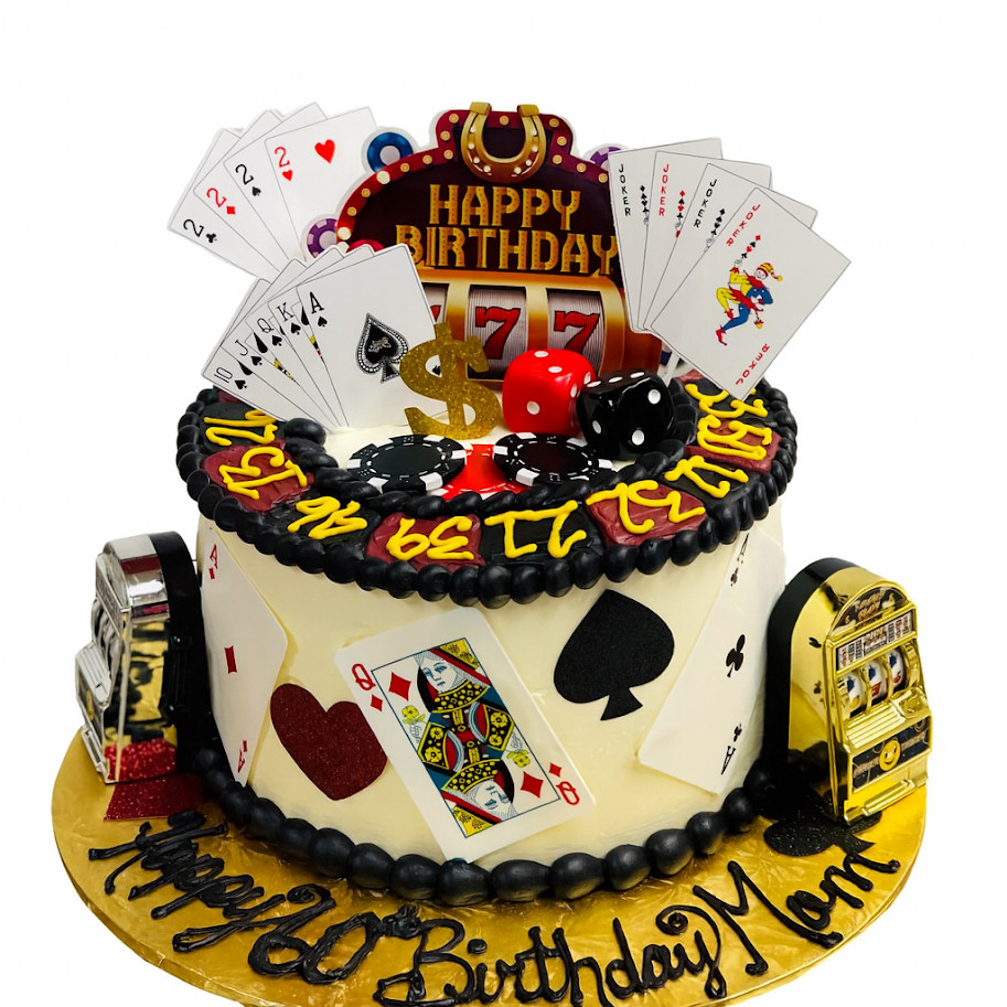 Casino birthday cake in ivory buttercream with a black pearl border and a piped roulette ring, dressed with fondant playing cards, poker chips, dice and slot-machine figures, lettered Happy 60th Birthday Mom on the gold board.